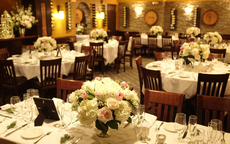 Party room with set tables and flower arrangements