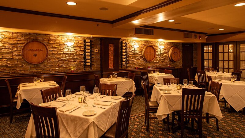 Dining room with set tables and wine barrel wall decorations