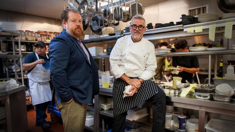 Restaurant owners standing in kitchen