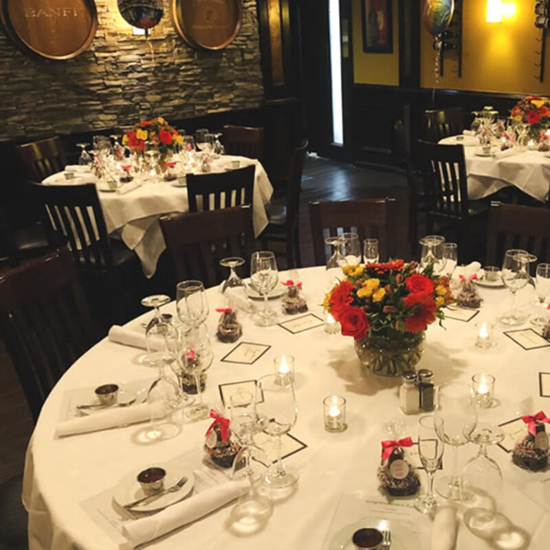 Party room with view of round tables with flower arrangements